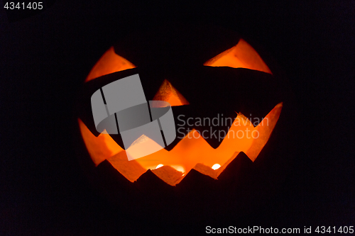 Image of halloween jack-o-lantern burning in darkness