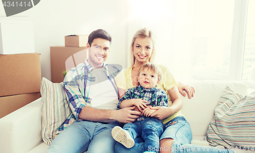 Image of happy family with boxes moving to new home