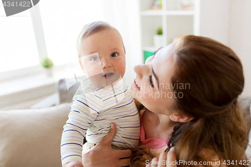 Image of happy young mother with little baby at home