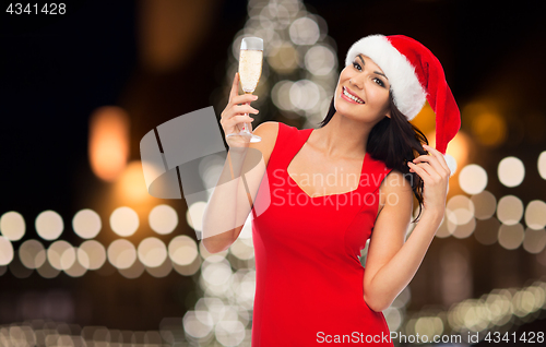 Image of beautiful sexy woman in santa hat and red dress