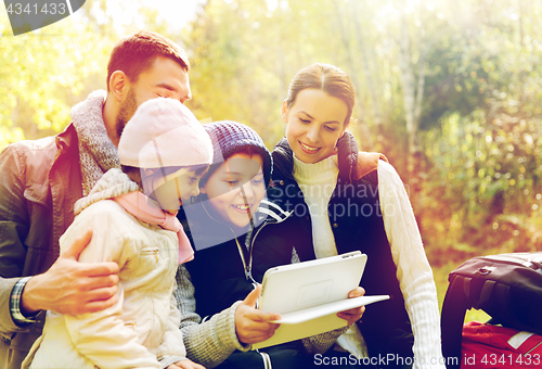 Image of happy family with tablet pc and backpacks at camp