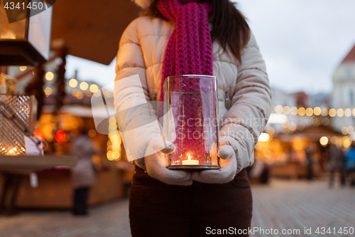 Image of woman with candle in lantern at christmas market