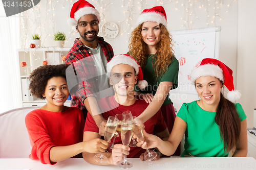 Image of happy team celebrating christmas at office party