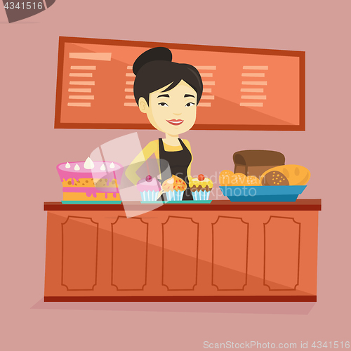 Image of Worker standing behind the counter at the bakery.