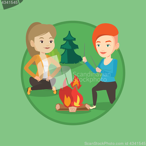 Image of Two friends sitting around bonfire in camping.