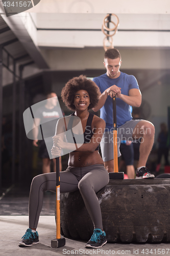 Image of multiethnic couple after workout with hammer