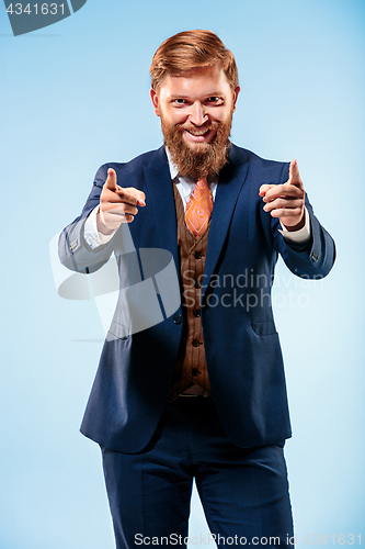 Image of Portrait of a business man isolated on blue background.