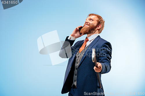 Image of The barded man in a suit holding cane.