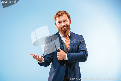 Image of Portrait of a business man isolated on blue background.