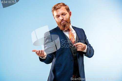 Image of Portrait of a business man isolated on blue background.