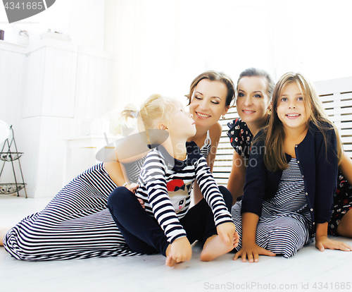 Image of Mature sisters twins at home with little daughter, happy family 