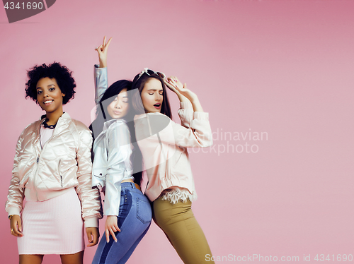 Image of different nation girls with diversuty in skin, hair. Asian, scandinavian, african american cheerful emotional posing on pink background, woman day celebration, lifestyle people concept 