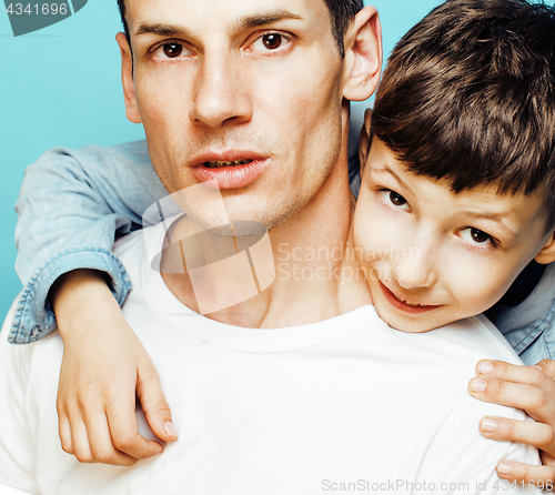 Image of young pretty man model with little cute son playing together, lifestyle modern people concept, family male