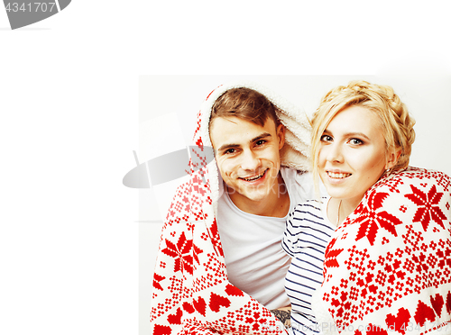 Image of young pretty teenage couple at Christmas time warming in red dec