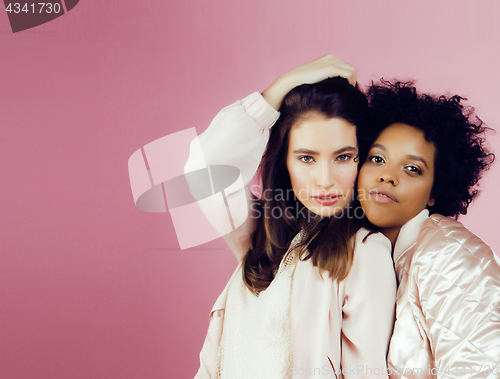 Image of different nation girls with diversuty in skin, hair. Asian, scandinavian, african american cheerful emotional posing on pink background, woman day celebration, lifestyle people concept 