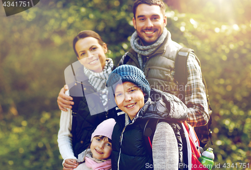 Image of happy family with backpacks hiking