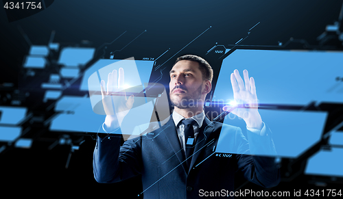 Image of businessman working with virtual screen
