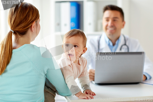 Image of woman with baby and doctor with laptop at clinic