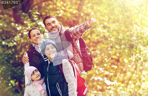 Image of happy family with backpacks hiking