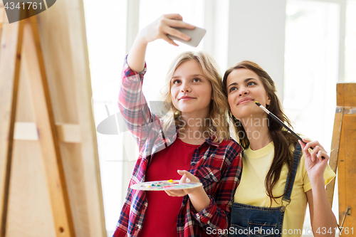 Image of artist girls taking selfie at art studio or school