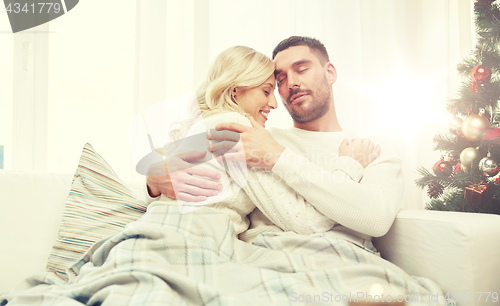 Image of happy couple at home with christmas tree