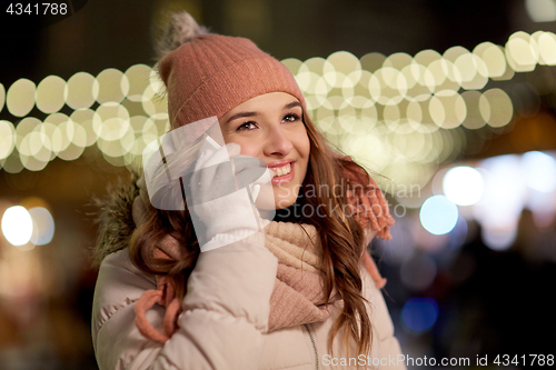 Image of happy woman calling on smartphone at christmas