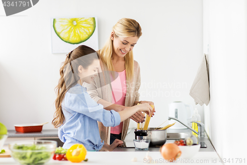 Image of happy family cooking food at home kitchen