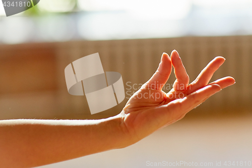 Image of hand of meditating yogi woman showing gyan mudra