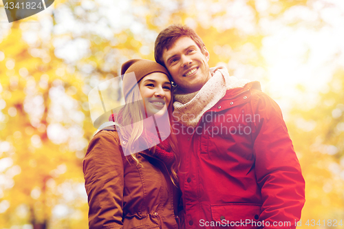 Image of happy young couple walking in autumn park