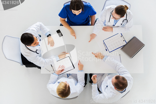 Image of group of doctors with cardiograms working at table