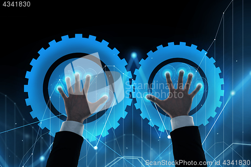 Image of businessman hands with virtual cogwheels