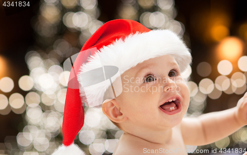 Image of close up of little baby in santa hat at christmas