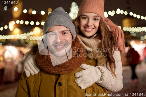 Image of happy couple hugging at christmas tree