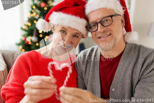 Image of close up of happy senior couple at christmas