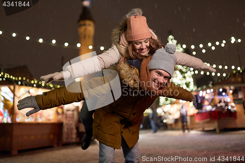 Image of happy couple having fun at christmas market