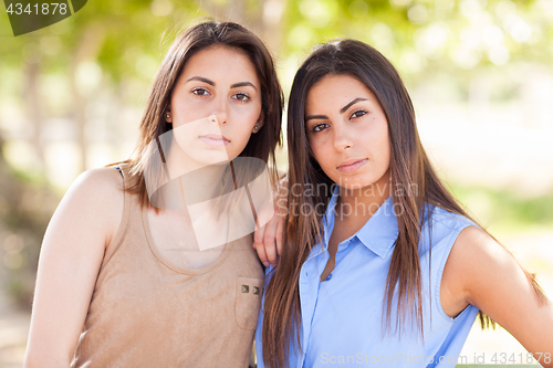 Image of Two Beautiful Ethnic Twin Sisters Portrait Outdoors.