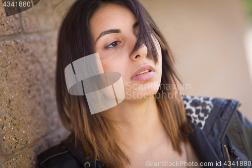 Image of Beautiful Meloncholy Mixed Race Young Woman Portrait Outside.