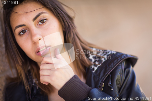 Image of Beautiful Meloncholy Mixed Race Young Woman Portrait Outside.