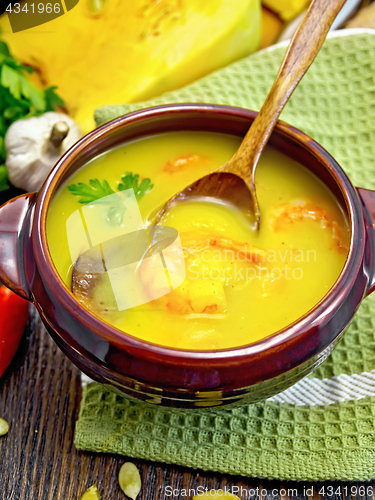 Image of Soup-puree pumpkin with prawns and champignons on dark board