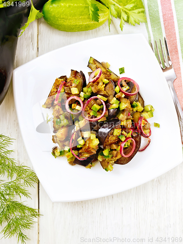 Image of Salad from eggplant and cucumber in plate on board top