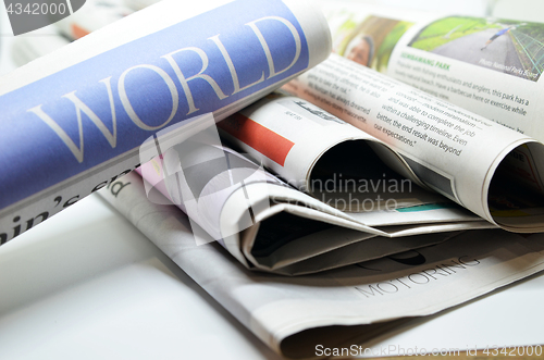 Image of Rolled newspaper with the world news