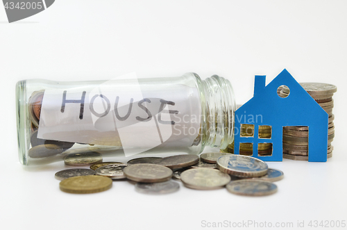 Image of House model and stacks of coins