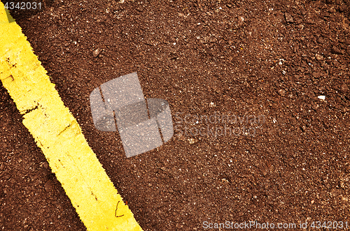 Image of Black road pavement with yellow line