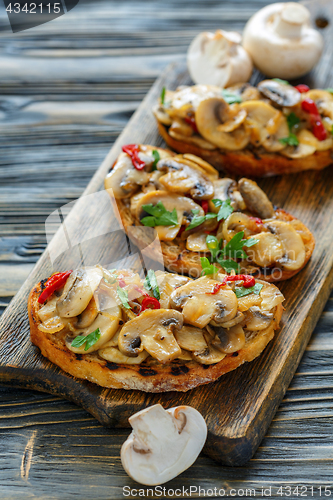 Image of Ciabatta grilled with fried mushrooms and onions.