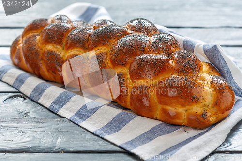 Image of Homemade bread challah with poppy seeds.