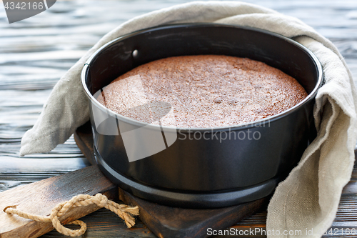 Image of Chocolate cake in a metal form.