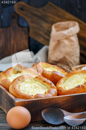 Image of Homemade pies with cottage cheese in a wooden box.