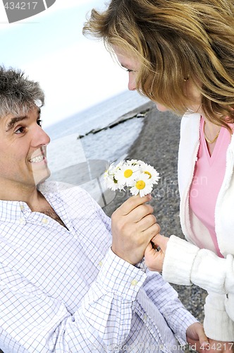 Image of Mature romantic couple with flowers