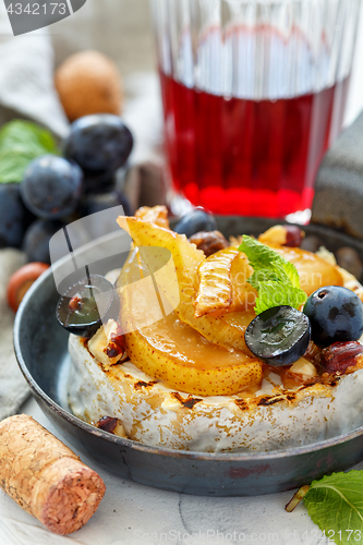 Image of Baked camembert with pears and grapes.