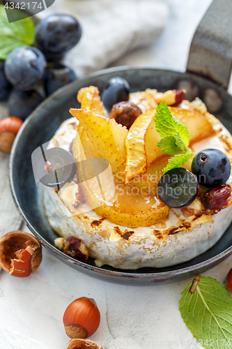 Image of Skillet with baked camembert,caramelized pears and grapes.
